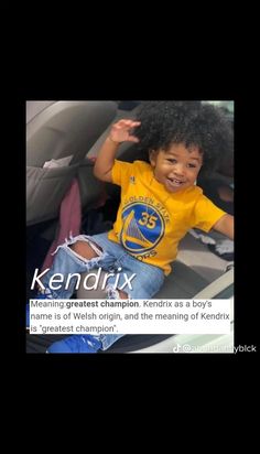 a little boy sitting in the back seat of a car with his hands up and smiling