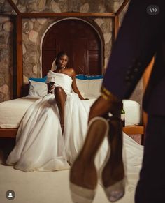 a woman sitting on top of a bed next to a man in a suit and tie