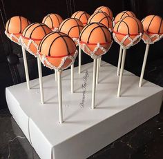 basketball cake pops are lined up on top of each other in the shape of balls