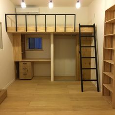 an empty room with wooden shelves and ladders