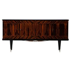 an art deco sideboard with wooden panels and metal legs