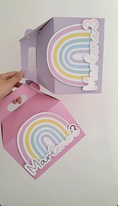 someone is opening up a box with a rainbow sticker on the front and side