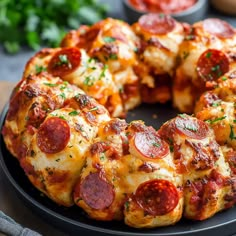 a pepperoni pizza bundt cake on a black plate