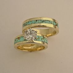 two gold rings with turquoise stones and a diamond in the center, set on top of each other