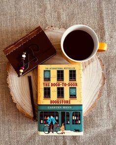 a book sitting on top of a table next to a cup of coffee