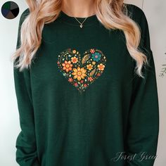 Flower Love Heart Unisex Pullover Sweatshirt | Floral Heart Jumper | Cottagecore Jumper  ✔️ Super comfy unisex heavy blend crewneck sweatshirt  ✔️ 50% cotton 50% polyester ✔️ Medium-heavy fabric (8.0 oz/yd² (271.25 g/m ✔️ No side seams ✔️ Ribbed knit elastic collar to help collar retain its shape ✔️ Sewn-in label 📏 Runs true to size ✨ Care instructions: Machine wash: cold (max 30C or 90F). Turn inside out before washing to protect the print. Non-chlorine: bleach as needed. Tumble dry: low heat. Winter Long Sleeve Sweatshirt With Heart Print, Winter Crew Neck Sweatshirt With Heart Print, Green Long Sleeve T-shirt With Floral Print, Winter Floral Print Sweatshirt, Winter Floral Print Hoodie Sweatshirt, Wildflower Sweatshirt, Boho Pullover, Cottagecore Clothes, Heart Sweatshirt