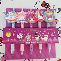 three hello kitty pen holders are on display