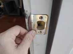 a person is opening the door with their finger