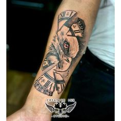 a man's arm with a clock and dog tattoo on it