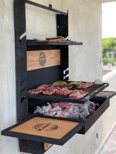 an outdoor bbq grill with meat on it