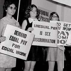 several women holding up signs in front of them