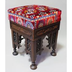 an ottoman sitting on top of a wooden table