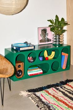 a green shelf with various items on it