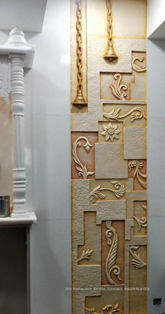 the wall is decorated with gold and white tiles