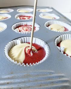 cupcake tins filled with red and white icing