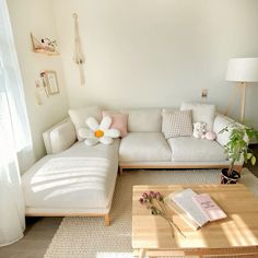 a living room with a white couch and coffee table