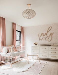 a baby's room with white furniture and pink curtains