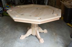 a wooden table sitting on top of a cement floor