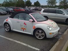 a hello kitty car parked in a parking lot