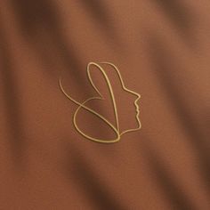 a woman's face is drawn on the side of a brown cloth with gold thread