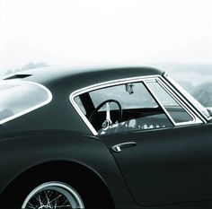 a black and white photo of a classic car