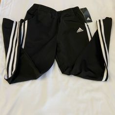 Black Adidas Athletic Pants For Girls With White Stripes On Each Side And Slant Pockets On Each Side, Size M (10/12) Black Stretch Sweatpants With Three Stripes, Stretch Black Sweatpants With Three Stripes, Black Adidas Sweatpants, Adidas Black Sporty Pants, Black Stretch Adidas Sweatpants, Black Adidas Stretch Sweatpants, Black Adidas Cotton Sweatpants, Adidas Black Cotton Sweatpants, Black Cotton Adidas Sweatpants