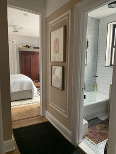 an open door leading to a bedroom with a bed and bathtub