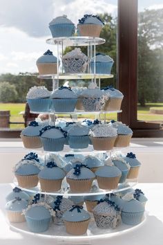 cupcakes are stacked on top of each other in the shape of a tower