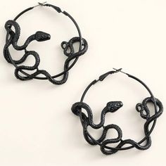 pair of black snake hoop earrings on white background