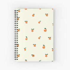 a spiral notebook with an orange pattern on it