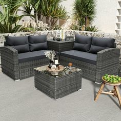 an outdoor living room with wicker furniture