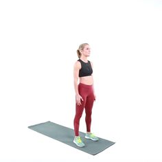 a woman is standing on a yoga mat