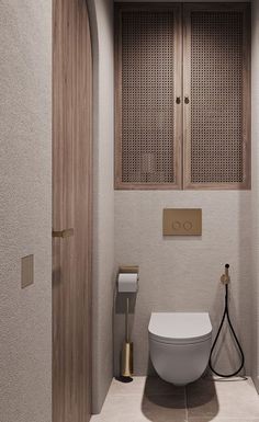 a bathroom with a white toilet sitting next to a wooden cabinet in the middle of it