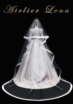 a white wedding dress on display in front of a black background with the words helen lena