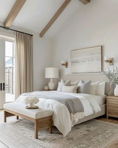 a bedroom with a large bed and white walls