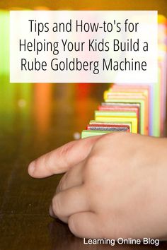 a hand pointing at a stack of cubes with the words tips and how to's for helping your kids build a rube goldberg machine