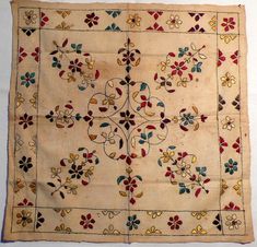 an old cloth with flowers and leaves on it