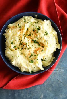 mashed potatoes in a blue bowl on a red cloth