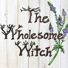 the wholesome witch embroidered on wood with purple flowers and green stems in it's center