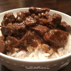 a white bowl filled with meat and rice