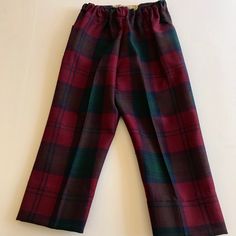 Vintage Hector Russell Kiltmaker Plaid Tartan Pants . A beautiful Made in Scotland 100 per cent pure wool Tartan pants . The colors are rich burgundy with greens and navy blue . The pants have elastic waistband in front with back pocket . Tagged size Four these may have been shortened or custom hemmed . A good 2 inches of hem available . Measure waist to cuff 20.5 inches , inseam 13 inches , waist 10 inches . I do have a matching Kilt skirt from same estate sale purchase listed . Pink Doll Dress, Checkered Trousers, Measure Waist, Royal Stewart Tartan, Tartan Pants, Kilt Skirt, Baby Coat, Rich Burgundy, Vintage Trousers