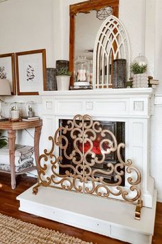 a living room with a fire place and pictures on the wall above it's mantle