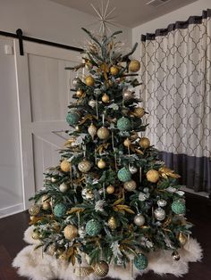 a decorated christmas tree with gold and green ornaments