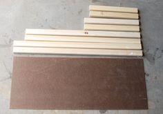 several pieces of wood sitting next to each other on top of a wooden flooring board