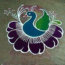 a peacock painted on the ground next to a brick wall