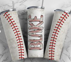 three personalized baseball tumblers with the word softball printed on them, sitting on a marble surface