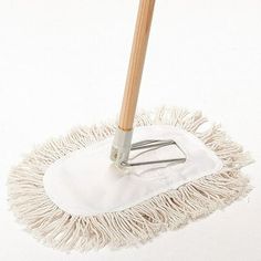 a mop with a wooden handle on a white surface