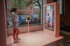 a woman is standing in front of a display