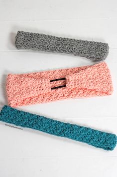 three crocheted headbands on a white background, one is blue and the other is pink