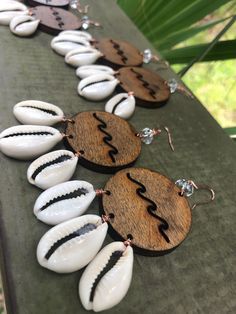 "Wooden wave & shell hoops/wave hoops Laser cut wooden waves with cowrie shells & crystal quartz All laser & design work is done in my savannah, GA studio Copper ear wires are nickel free  Lightweight 2.5\" earrings  Shop my store Http://www.etsy.com/shop/alchemyandthesea  Follow me for more designs  Http://www.instagram.com/alchemyandthesea" Unique Adjustable Hoop Earrings For The Beach, Beach Wooden Bead Earrings, Handmade Brown Shell-shaped Jewelry, Bohemian Jewelry With Wooden Beads And Shell, Handmade Brown Cowrie Shell Jewelry, Bohemian Brown Cowrie Shell Jewelry, Bohemian Brown Shell-shaped Jewelry, Shell Jewelry With Wooden Beads, Wooden Beads Earrings For Beach